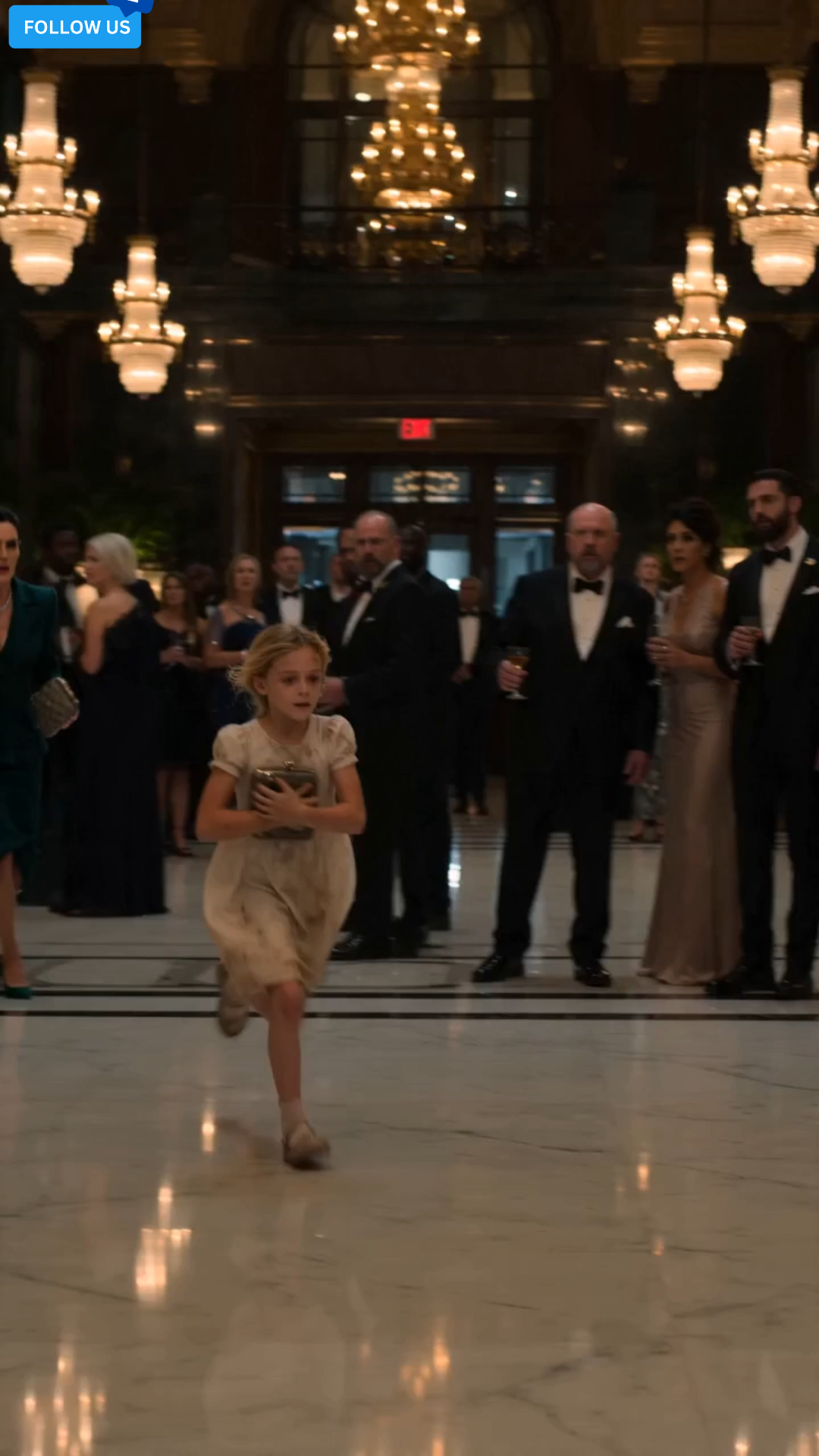The little girl slid violently across the polished marble floor, both tiny hands wrapped around the strap of an expensive designer bag.