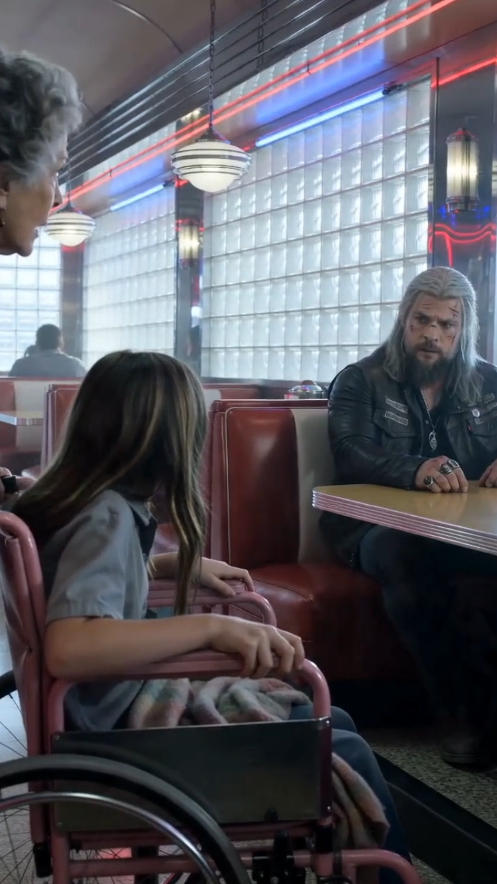 The Little Girl in the Purple Wheelchair Rolled Up to the Old Biker