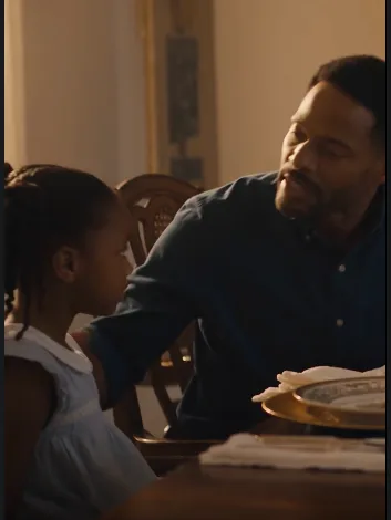 The little girl grabbed her father’s arm before he could drink from the glass