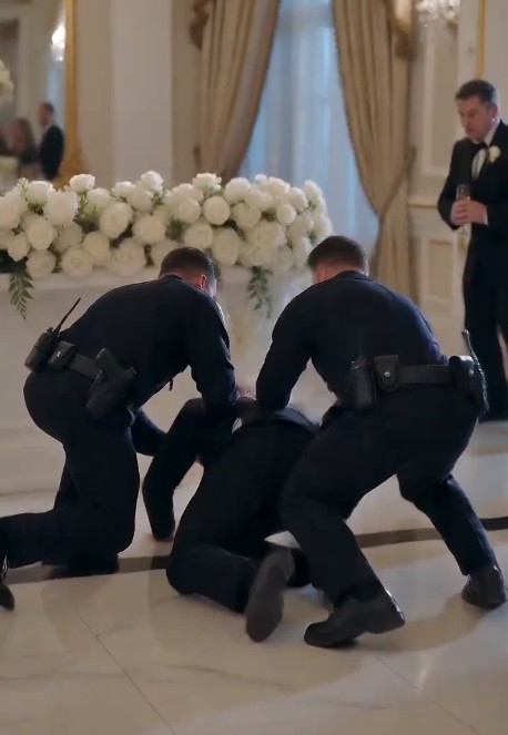 A high-stakes cinematic teaser transforms a fairytale wedding into a shocking scene of deception and criminal betrayal. The joyous celebration is abruptly interrupted when a frantic waitress rushes through the applauding guests, screaming as she slaps a silver serving spoon from the bride’s hand before she can taste the cake.