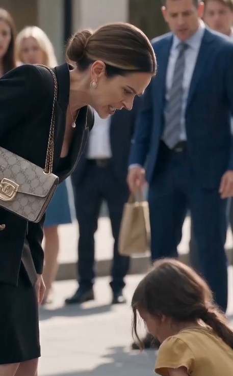 The rich woman stood frozen in the middle of the crowded street.  Her expensive purse hung forgotten from her shoulder.  Her eyes never left the small birthmark on the girl's heel.  The little girl backed away nervously.