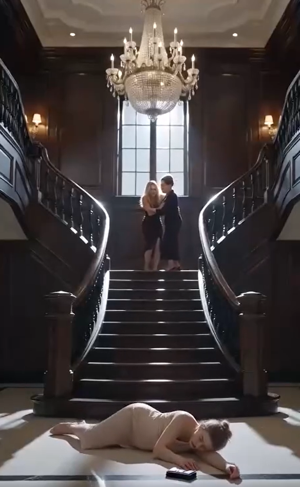Chapter 2: The Sirens at the Gate  The mansion remained eerily quiet after the call.  The blonde woman smirked as she adjusted her blouse, convinced she had already won.  "You finally learned your place," she said.  The pregnant woman didn't answer.  She simply held her aching stomach, breathing slowly as she waited.  The mother-in-law folded her arms.  "Delete whatever you just did on that phone," she ordered.  No response.  Thirty seconds later...  The silence outside shattered.  Multiple sirens echoed through the private estate.  Headlights swept across the mansion windows.  Black SUVs rolled through the front gate one after another.  Brakes screeched.  Car doors slammed.  Heavy footsteps rushed toward the house.  The blonde woman's smile disappeared.  "What... is that?"  The front door burst open.  Uniformed officers entered first.  Behind them walked Detective Rose.  Calm.  Composed.  Holding a thick investigation file.  She looked directly at the pregnant woman.  "I'm sorry we couldn't come sooner."  Then she faced the family.  "No one leaves this house."  The mother-in-law laughed nervously.  "This is ridiculous. She's lying."  Detective Rose slowly raised her hand.  Several officers immediately began photographing the staircase, the blood on the hardwood floor, and the victim's injuries.  Then Rose spoke quietly.  "We've been documenting this family for eight months."  The room froze.