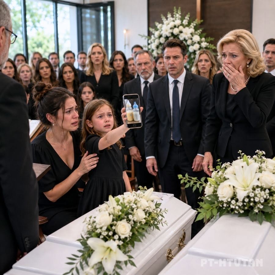 While We Were Saying Goodbye to My Infant Twins, My Mother-in-Law Stood Beside Their White Caskets and Said, “God Knew They Weren’t Safe With Her.” My Husband Stared at the Floor and Let His Family Blame Me. I could not defend myself through the grief. Then my eight-year-old daughter walked toward the minister, raised an old phone, and asked, “Should I show everyone what Grandma poured into the babies’ bottles when Dad was away?”...