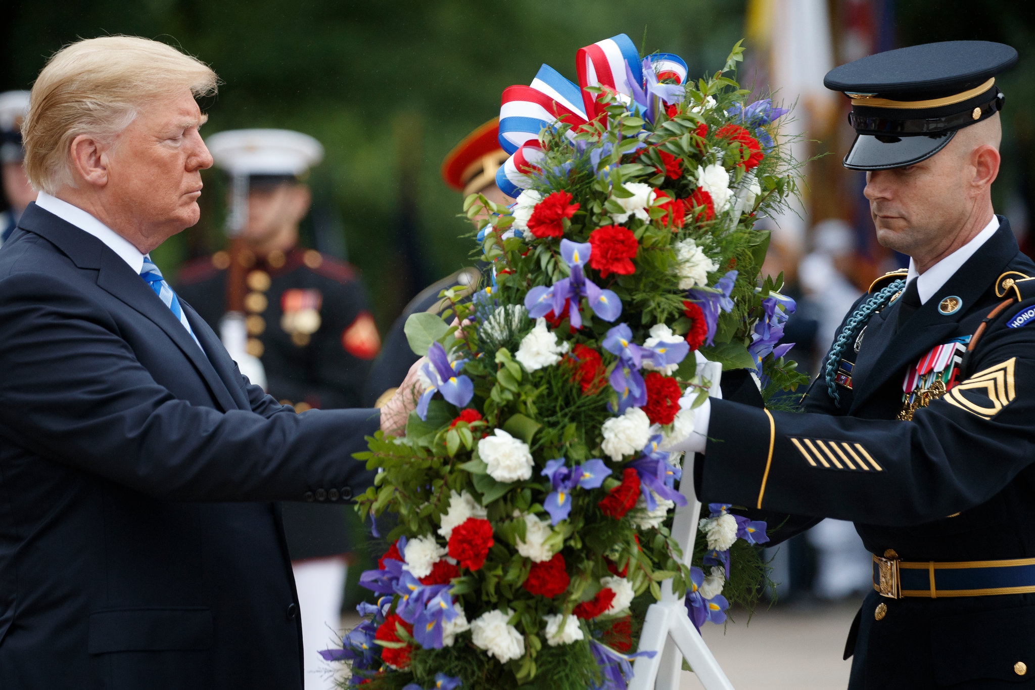 People Focused On Trump’s Face At Arlington — But The Real Tension May Have Been Happening Around Him