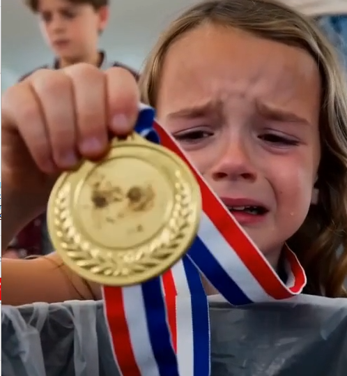 Karen ripped all three medals from Ella’s hands before I could reach them.