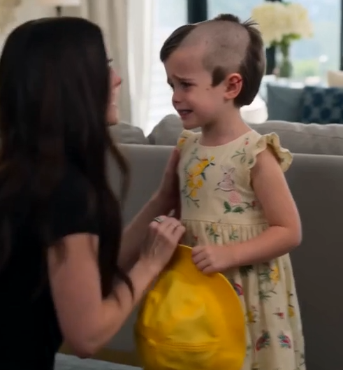 Her hair had been hacked into uneven patches, and a dried line of blood marked the skin above her left ear.