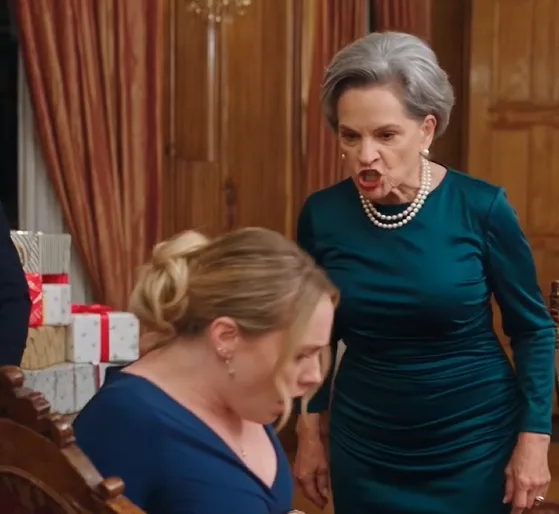 Bianca violently shoves pregnant Serena out of the ornate chair beside the head of the table. Serena crashes against the carpet, immediately curling one arm protectively around her belly.