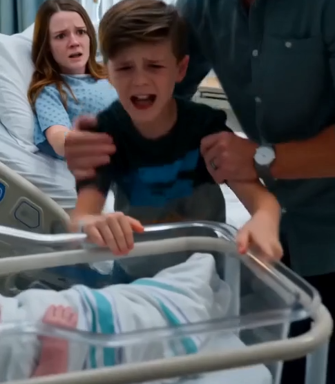 Eli blocked the bassinet before Luke could push it toward my hospital bed.