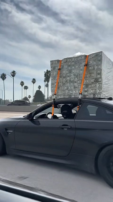 MASKED DRIVER SPOTTED WITH MILLIONS STRAPPED TO A SPORTS CAR—BUT ONE DETAIL HAS EVERYONE ARGUING