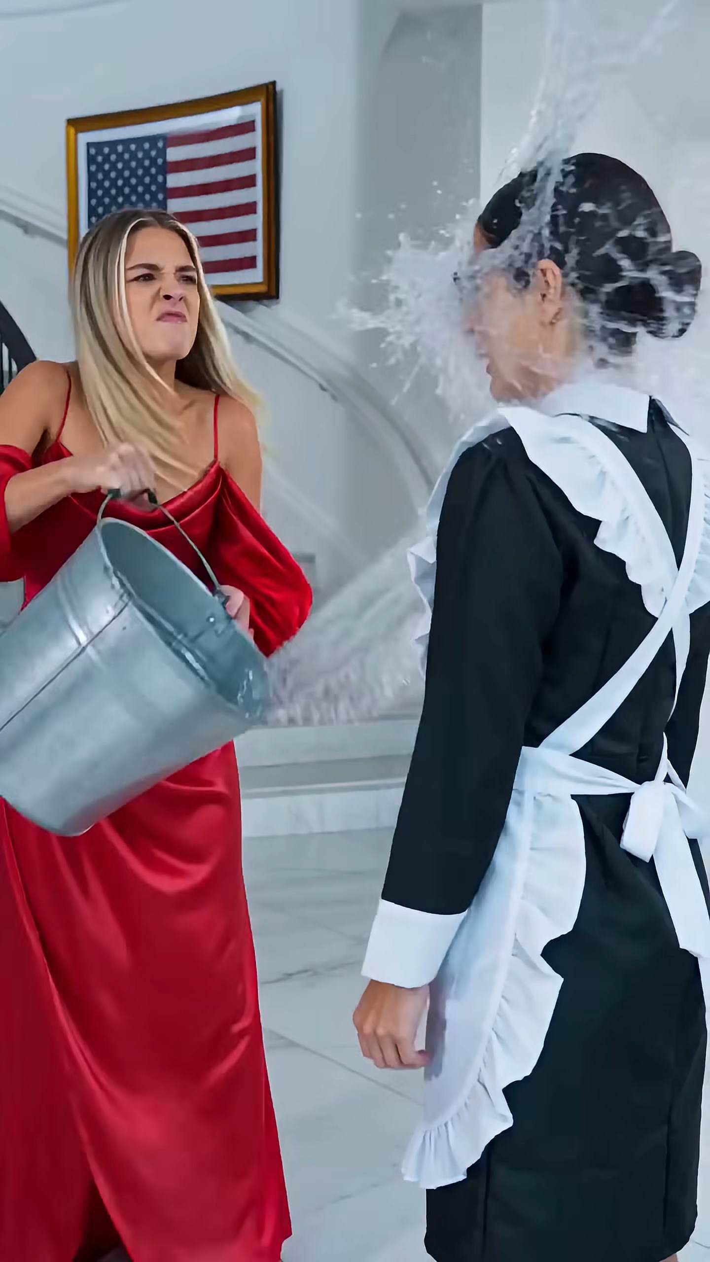 SPLASH! The filthy water hit the maid directly in the face—and the woman in the red silk dress actually smiled.