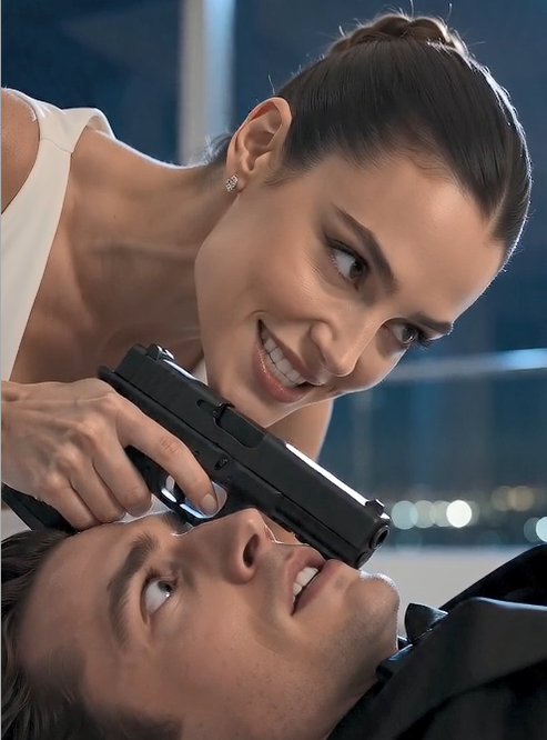 The cold steel of the Glock rested heavily against Julian’s temple. Elena didn't flinch. Her breathing was perfectly controlled, a stark contrast to the rapid rise and fall of Julian’s chest. The romantic facade of the Manhattan penthouse—the scattered rose petals, the soft jazz playing in the background, her elegant white evening gown—felt like a distant memory now.