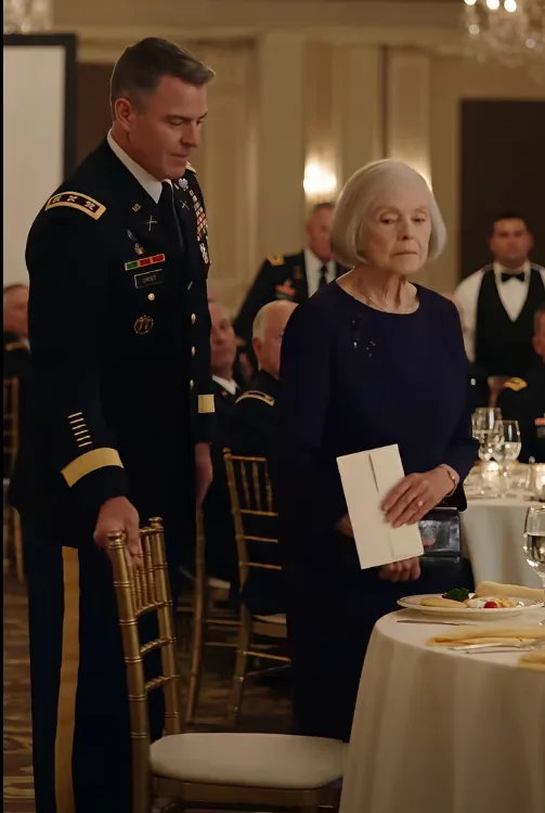 Colonel Derek Maddox ordered an elderly woman removed from the honored-guests table because