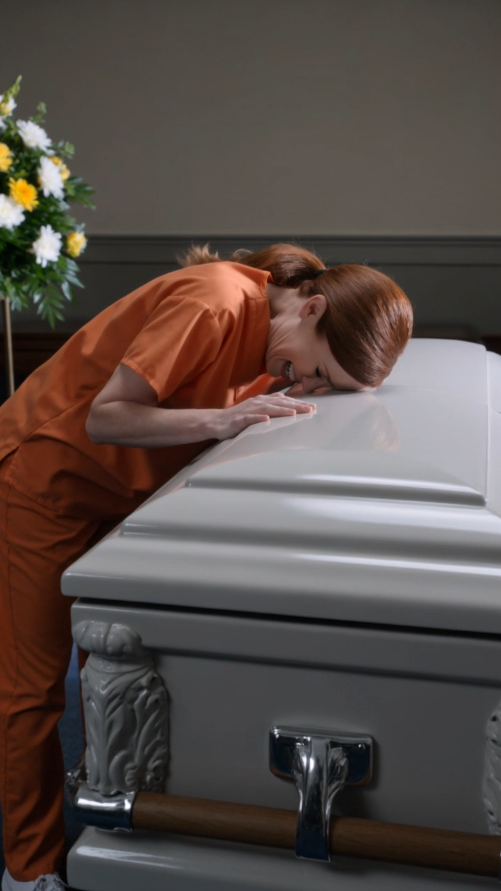 Tessa Ward raised an axe over a white casket while forty mourners screamed at her to put it down