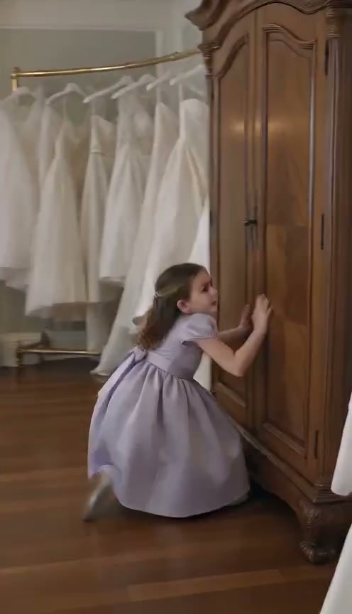 Minutes before an elegant wedding, a playful little girl slips beside an old wardrobe, accidentally pushing the door open just enough to glimpse something hidden in the darkness. Her terrified scream