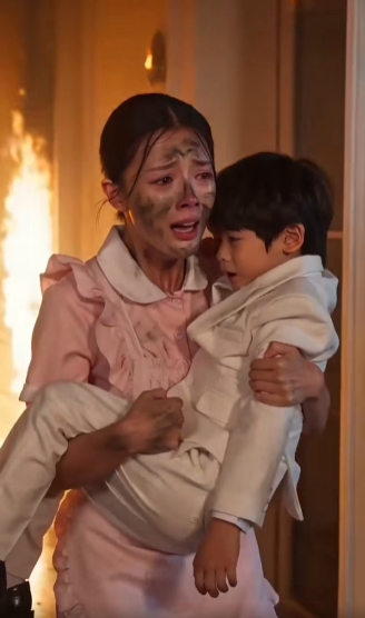 A massive house on fire raged just beyond the grand entrance, with thick smoke billowing darkly into the background