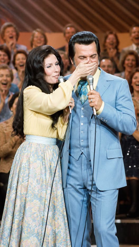 The Night Loretta Lynn Had Conway Twitty Speechless and the Crowd Couldn’t Stop Laughing  Post Views: 195 INTRODUCTION:   There are many legendary partnerships in the history of Country Music, but few have captured the hearts of fans quite like Loretta Lynn and Conway Twitty. Their voices blended with remarkable chemistry, their performances felt authentic, and their friendship created moments that audiences still cherish decades later. Yet some of their most unforgettable memories had little to do with chart positions or awards. Instead, they came from the spontaneous, unscripted moments that revealed who they truly were behind the music.   One of those moments occurred when Loretta Lynn simply could not stop teasing Conway Twitty on stage.  The audience expected a professional duet from two of the biggest stars in Country Music. What they got was something even better. They witnessed genuine friendship unfolding in real time. Laughter replaced perfection. Playfulness interrupted the performance. And for a few magical minutes, fans saw two icons behaving less like superstars and more like lifelong friends enjoying each other’s company.  These are the moments that often survive longer than hit records. Songs may climb charts and eventually fade from radio playlists, but memories of authentic human connection endure. The story of Loretta Lynn teasing Conway Twitty on stage remains a beloved example of why audiences fell in love with them in the first place—not just because they could sing, but because they could make people feel like they were part of the family.  Their chemistry was real, and that reality made every performance unforgettable.  For fans who witnessed it, it was a night they would never forget.  A Partnership Unlike Any Other in Country Music When discussing the golden era of Country Music, it is impossible to ignore the extraordinary partnership between Loretta Lynn and Conway Twitty. Throughout the 1970s and early 1980s, they became one of the genre’s most successful duet teams.  Songs such as After the Fire Is Gone, Louisiana Woman, Mississippi Man, and Lead Me On helped establish them as a dominant force in country entertainment. Their records sold millions, and their concerts consistently attracted enthusiastic audiences across America.  What made their partnership unique was not simply vocal compatibility. Plenty of artists could harmonize beautifully. The real secret was chemistry.  Fans believed every word they sang because they appeared so comfortable together. There was a natural ease in their interactions that could not be manufactured by producers or managers. Their conversations felt genuine. Their jokes landed naturally. Their stage presence radiated warmth.  As a result, audiences often felt they were watching old friends rather than professional performers.  That authenticity became one of their greatest strengths.  Loretta Lynn’s Playful Personality Although Loretta Lynn became famous for powerful songs and fearless storytelling, those who knew her often spoke about her mischievous sense of humor.  Behind the scenes, she loved practical jokes, playful remarks, and unexpected moments that caught people off guard.  Meanwhile, Conway Twitty possessed a more polished stage image. He was known for his smooth delivery, charismatic appearance, and confident professionalism.  This difference created the perfect dynamic.  Loretta Lynn enjoyed pushing boundaries.  Conway Twitty often became the target.  And fans loved every second of it.  During live performances, Loretta Lynn occasionally found opportunities to interrupt rehearsed routines with spontaneous humor. Sometimes it was a funny comment. Sometimes it was an unexpected gesture. Sometimes it was simply a look that caused both performers to lose composure.  The best entertainment often happens when performers forget they are supposed to be performing.  That truth became especially evident whenever these two legends shared a stage.  The Night Conway Twitty Couldn’t Keep a Straight Face One particularly memorable performance demonstrated exactly why audiences adored them.  As the duo performed before a packed crowd, Loretta Lynn began teasing Conway Twitty in the middle of the show. What started as playful banter quickly escalated into a hilarious exchange.  She knew exactly how to push his buttons.  The more she joked, the harder it became for Conway Twitty to maintain his professional composure.  Fans watched as one of Country Music’s smoothest entertainers struggled to keep a straight face.  The audience immediately sensed something unusual was happening.  Instead of focusing solely on the song, they became invested in the interaction unfolding before them.  Laughter spread throughout the venue.  The crowd was no longer watching a scripted concert.  They were witnessing a genuine friendship.  Sometimes the loudest applause comes not from perfect singing, but from a moment of pure human connection.  That night proved exactly that.  Why Fans Loved These Moments Modern audiences often associate celebrity culture with carefully controlled public images. Every appearance is managed. Every statement is reviewed. Every moment is calculated.  But the era of Loretta Lynn and Conway Twitty felt different.  Fans appreciated imperfections.  They embraced spontaneity.  They enjoyed seeing performers act naturally.  When Loretta Lynn teased Conway Twitty, it reminded audiences that behind the fame were real people with real friendships.  That authenticity strengthened the bond between artist and fan.  People did not simply admire Loretta Lynn and Conway Twitty.  They felt connected to them.  Many concertgoers later recalled these humorous interactions with greater affection than some of the songs themselves.  That is the power of genuine personality.  Beyond the Laughter While the story is often remembered because it is funny, it also reveals something deeper about both artists.  Their willingness to laugh together reflected mutual trust.  Not every performer would be comfortable becoming the punchline in front of thousands of people.  Yet Conway Twitty understood Loretta Lynn’s intentions.  The teasing was never mean-spirited.  It came from affection.  Likewise, Loretta Lynn knew Conway Twitty well enough to understand how far she could go before the joke became too much.  This delicate balance is difficult to achieve.  It requires respect.  It requires friendship.  And it requires years of shared experiences.  Those qualities defined their partnership both on and off stage.  Great duets are built on harmony. Legendary partnerships are built on trust.  The relationship between Loretta Lynn and Conway Twitty embodied both.  A Legacy That Still Makes Fans Smile Decades later, fans continue to revisit performances by Loretta Lynn and Conway Twitty not only for the music but for the moments between the music.  Their biggest hits remain timeless treasures of Country Music, yet stories like this help explain why their legacy remains so powerful.  They gave audiences something increasingly rare.  Authenticity.  Joy.  Friendship.  Humanity.  When Loretta Lynn couldn’t stop teasing Conway Twitty on stage, she accidentally created a memory that would outlast countless perfectly executed performances.  The crowd laughed.  Conway Twitty struggled to maintain his composure.  And Loretta Lynn delighted in every second of it.  For a brief moment, two legends reminded everyone that music is not just about notes and lyrics. It is about connection. It is about shared experiences. It is about laughter echoing through a concert hall long after the final song has ended.  And that is precisely why the story continues to resonate today.  Long after the lights went out and the applause faded, fans remembered the laughter.  And perhaps that is the greatest compliment any performer can receive.  Post navigation The Night Jim Reeves Swore He Would Never Return To Nashville Again After The Crowd’s Love Brought Him To Tears Fans Came for Romance, but Conway Twitty and Loretta Lynn Turned the Stage Into Country Music’s Funniest Show Related Post News Behind The Locked Gates: The Chilling Truth About Elvis Presley’s Final Months Of Fear, Isolation, And Paranoia News The Untold Heartbreak of George Strait: The Tragic 1986 Crash That Changed His Life Forever News The Degenerative Curse That Changed Everything: How Alan Jackson’s Inherited Disease Became the Toughest Battle of His Life Search Search