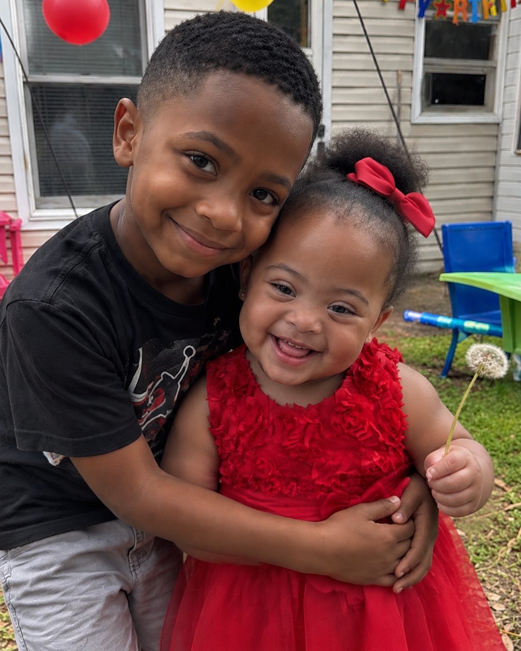 My 8-year-old son gave up his lunch money to buy a little girl with Down syndrome a red dress—the next morning, our lawn was covered with lunchboxes, but what was inside the biggest one made him go pale.