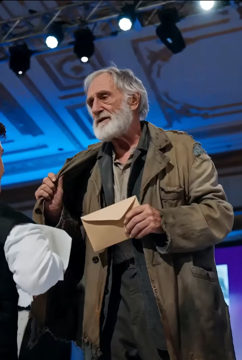 The female director took the old man's arm and pulled him away from the donor's table