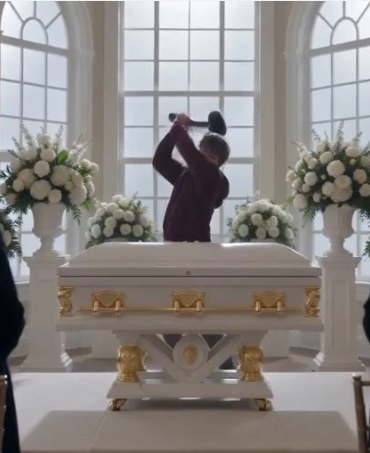 "The crystal chandelier cast a cold, haunting light over the extravagant floral arrangements of the most expensive funeral in the city.
