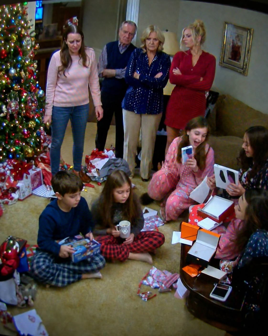 New My children sat on my parents’ living room floor holding a dollar-store board game and a cheap snowman mug while my sister’s kids tore open iPhones, a MacBook, jewelry, and a Disney cruise packet I had secretly paid for
