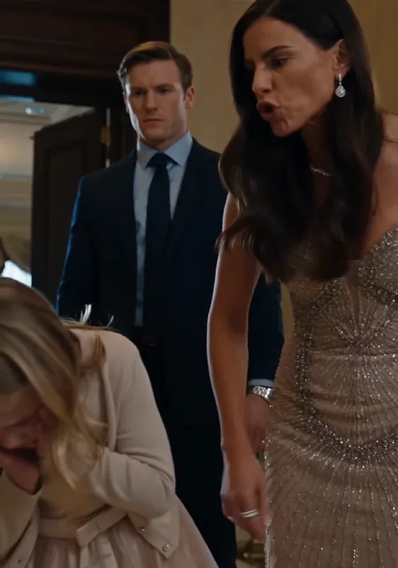 Vanessa violently strikes Elsie across the face beside the marble table in the foyer.