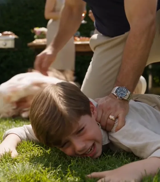 Javier is already pinning Leo face-down on the lawn with one knee pressed against his back.