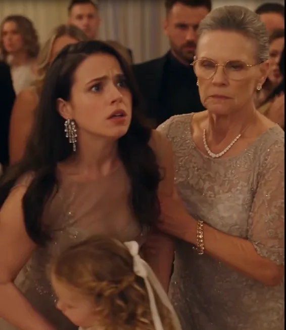 He violently shoves the little girl onto the ballroom floor.