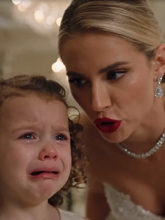 Bianca Hale grabbed the hem of three-year-old Emma Carbone’s flower-girl dress and cut a long section away with the dressmaking scissors.