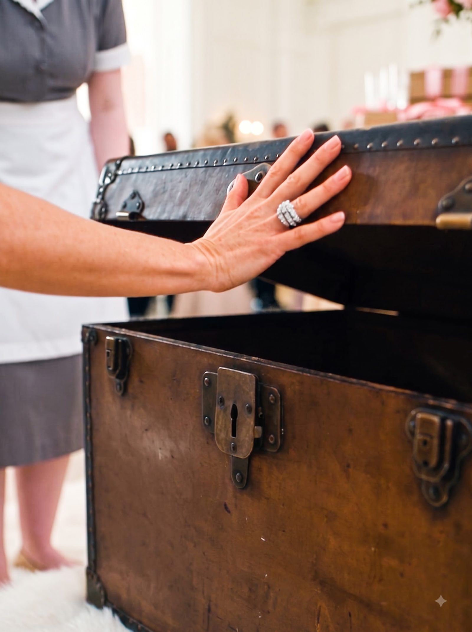 At a crowded birthday reception, the lid of a large traveling trunk suddenly moved from inside.
