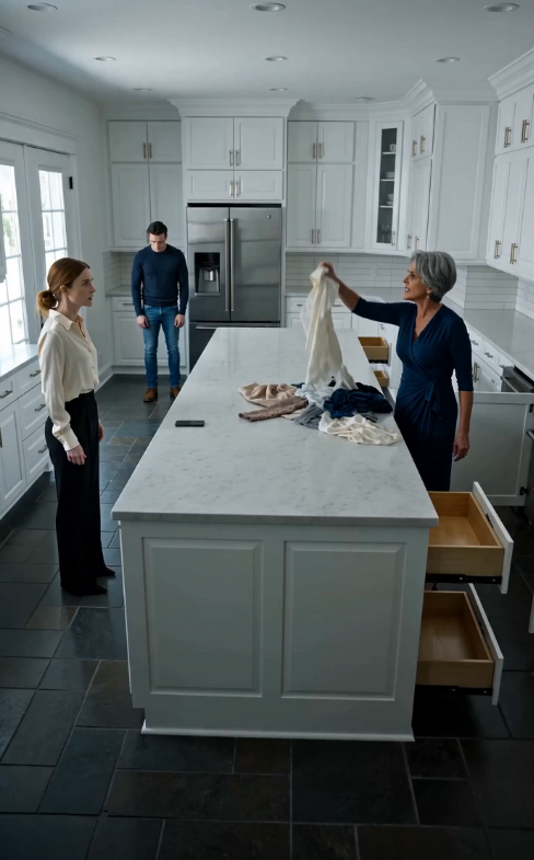 My mother-in-law tore my clothes apart in my kitchen while screaming that everything belonged to her son. My husband stood there silently, letting her humiliate me. Less than twenty-four hours later, she learned I owned the house, the company, and his entire career...